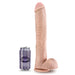 Large realistic beige dildo next to a soda can on a white background