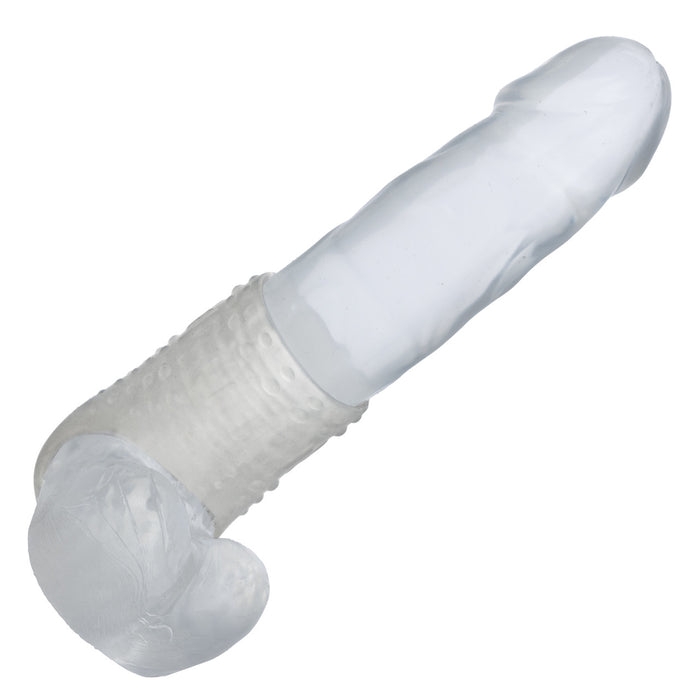 Clear textured penis sleeve worn on a clear dildo on a white background