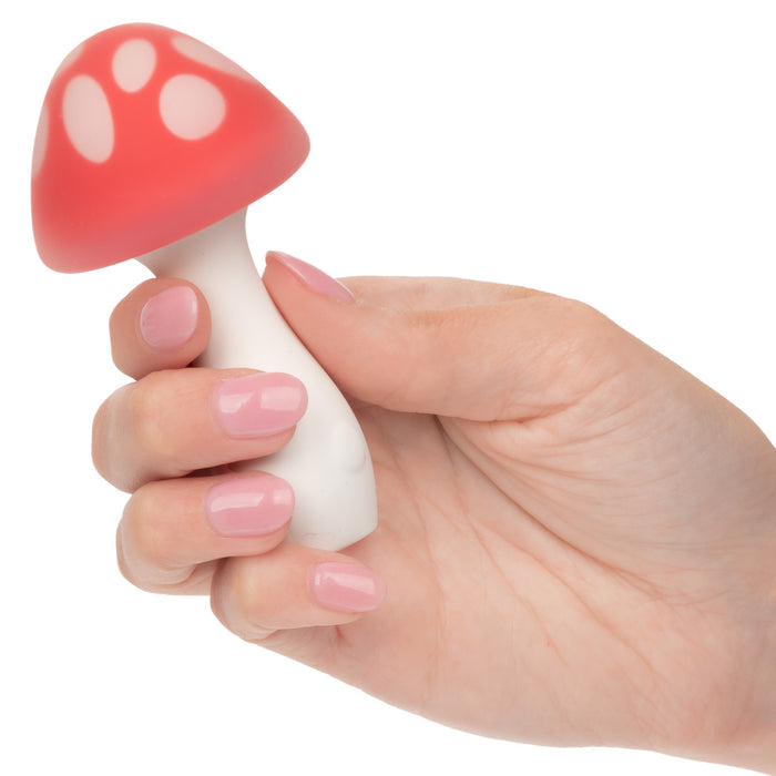Hand holding Muff Shroom red and white mushroom-shaped vibrator