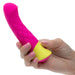 Hand holding a hot pink and yellow silicone G-spot vibrator with quilted design