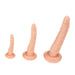 Three beige dildos in different sizes on a white b ackground