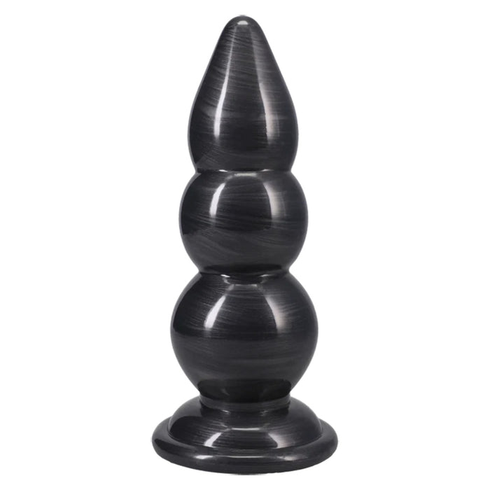 A black PVC butt plug with a tiered, stacked design and a flared base, shown against a plain white background.