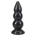 A black PVC butt plug with a tiered, stacked design and a flared base, shown against a plain white background.