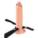 Realistic beige silicone dildo standing vertically with nylon harness on a white background