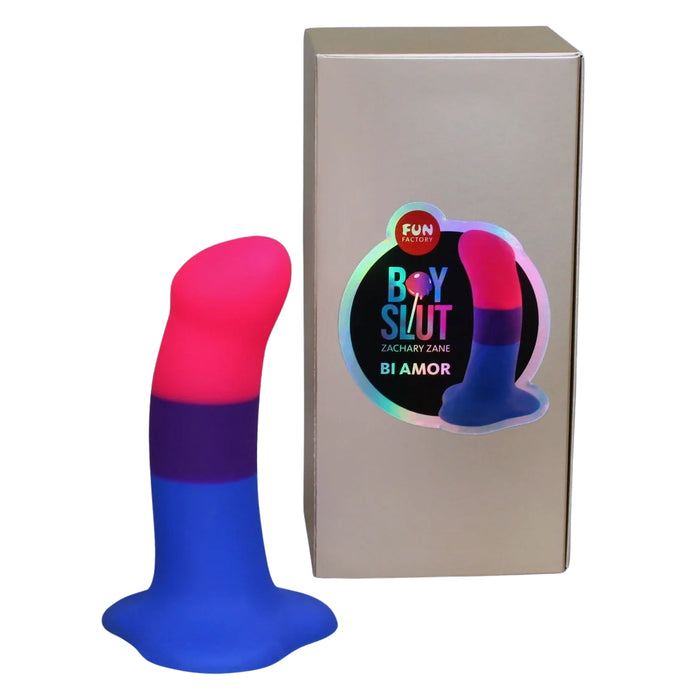 Blue and pink silicone dildo with packaging labeled 'Fun Factory Boy Slut Zachary Zane Bi Amor' on a white background