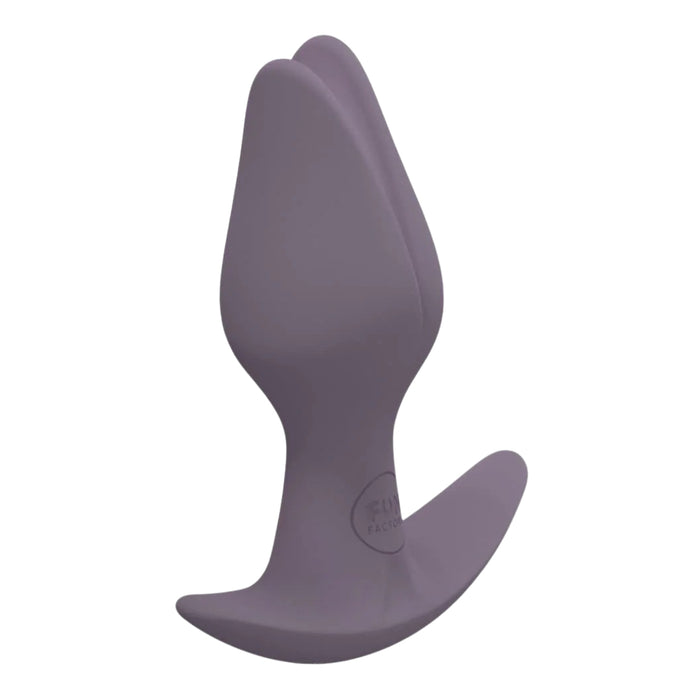 Purple silicone butt plug on a white background