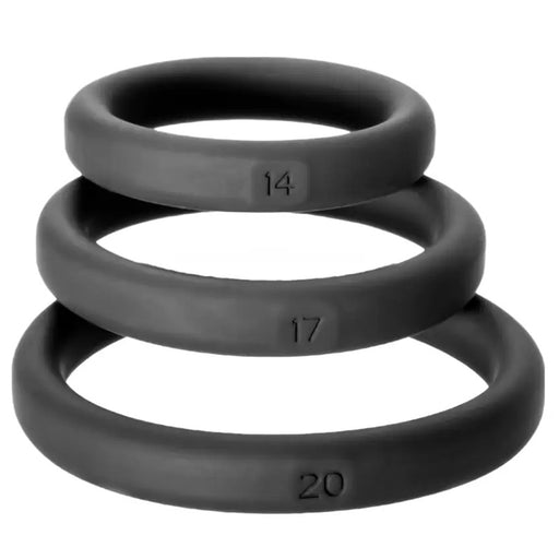 Three black silicone cock rings stacked in order of sizes #14, #17, and #20, each with markings indicating their size.
