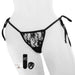 Mannequin wearing black lace panty with vibrating bullet, remote, and charge cable in the foreground