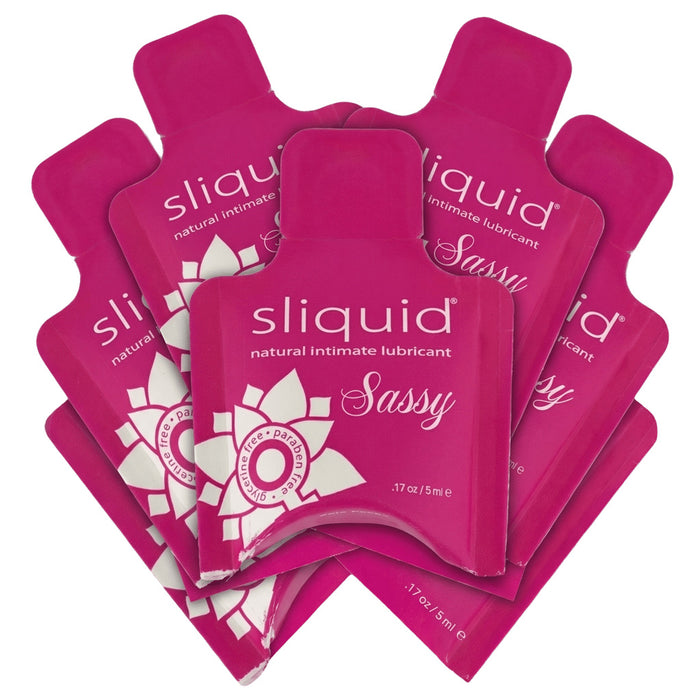 Multiple cardboard pillow packages of Sliquid Sassy anal lubricant on a white background